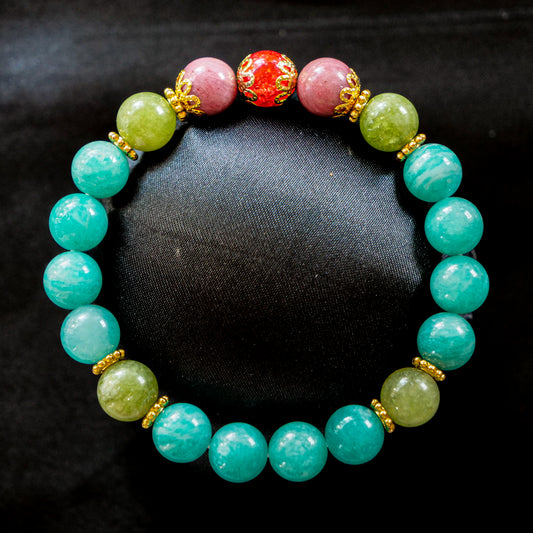 Venusaur inspired bracelet featuring Brazilian amazonite, peridot, rhodonite, and a red cracked quartz centerpiece with gold accents.