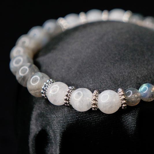 Bracelet with gray beads on a black stand